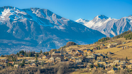 View of a pretty little mountain village, perched at an altitude of 1200 m, at the end of winter. South Alps, France.