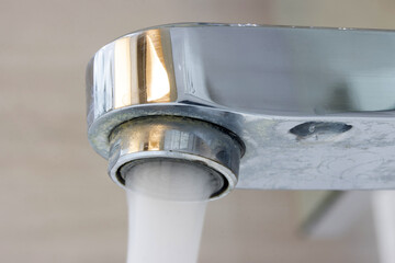 Water flowing from a water tap, macro view