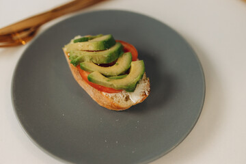 toast with avocado in the kitchen. Cooking breakfast
