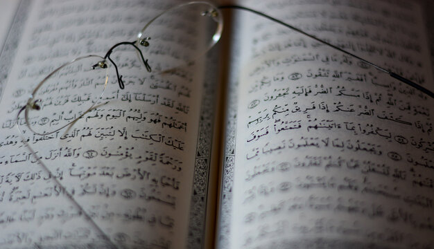 glasses over the open Koran