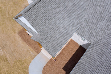 Aerial view rooftop construction the edge of roof shingles on top of the new house asphalt tiles