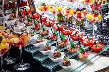 Various snacks, buffet table with different dishes.