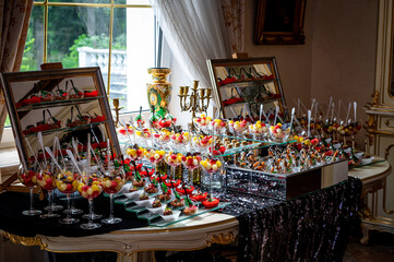 Various snacks, buffet table with different dishes.