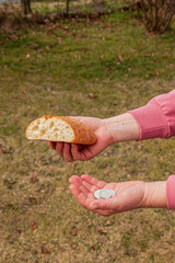 Fototapeta na wymiar Last money for bread. Bread in the hand of a middle-aged woman. The concept of the world food crisis associated with the war in Ukraine