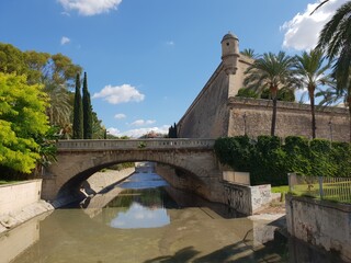 Bridge over the Torrent (= dry river bed, water only after rain like on the picture) de sa riera in Palma, Mallorca, Balearic Islands, Spain, on the right the Es Baluards fortress