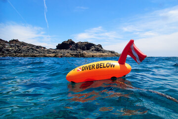 Orange diving buoy with text 