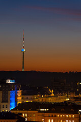 Vilnius tv tower illuminated by yellow and blue after sunset