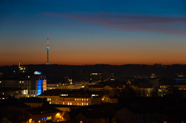 Vilnius tv tower illuminated by yellow and blue after sunset