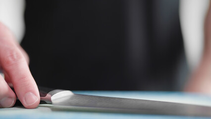 Cook put down the sharp knife on desk in kitchen close-up