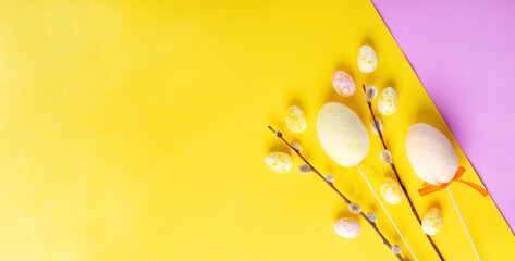 Web banner with Easter eggs and willow twigs on yellow background. Mockup with copy space