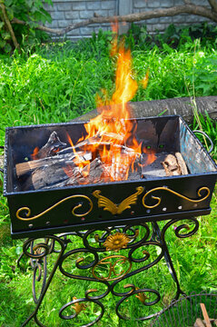 Lighting a fire in a metal grill for cooking kebabs and steaks