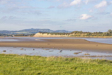 The River Severn at low tide at Arlingham, Gloucestershire, England UK - Westbury Garden Cliff is on the far bank.
