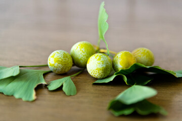 Green ginkgo fruit on wooden table