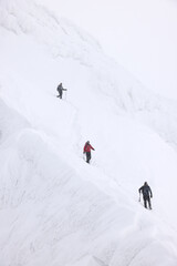 Fototapeta na wymiar Mountaineers climbing with crampons in the Transylvanian Alps, Romania, Europe