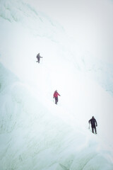 Group of alpinists trekking in harsh winter conditions in the Transylvanian Alps, Romania, Europe