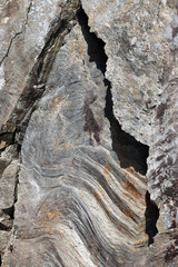 Rock texture. Stone background. Old weathered crumbling mountain surface in cracks background. Light brown rock background.