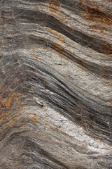 Rock texture. Stone background. Old weathered crumbling mountain surface in cracks background. Light brown rock background.
