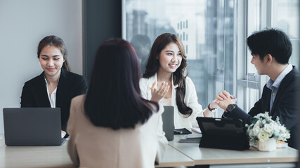 Meeting room atmosphere and business groups are meeting, discussing and planning business operations for more profitable growth. Concept of business meeting and company administration.