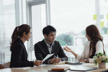 Meeting room atmosphere and business groups are meeting, discussing and planning business operations for more profitable growth. Concept of business meeting and company administration.