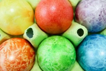 colorful easter eggs in a egg carton box close up