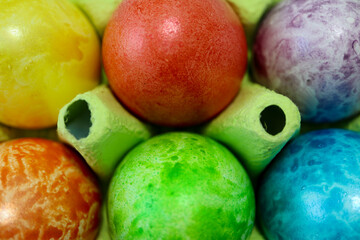 colorful easter eggs in a egg carton box close up