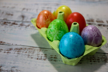 colorful easter eggs in a egg carton box close up