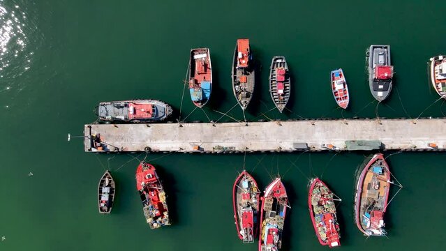 Aerial view of Kalk Bay harbour with colourful fishing boats, Cape Town, South Africa.