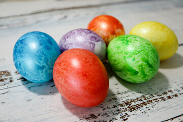 colorful easter eggs on wooden kitchen table close up
