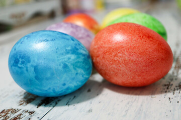 colorful easter eggs on wooden kitchen table close up