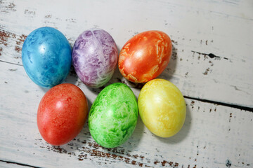 colorful easter eggs on wooden kitchen table close up
