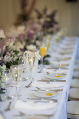 Flower table decorations for holidays and wedding dinner. Table set for holiday, event, party or wedding reception in a restaurant.