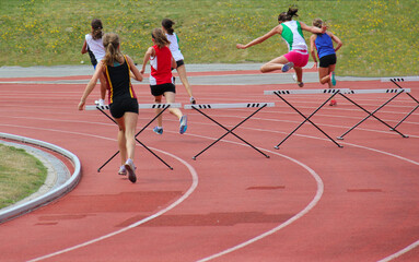 Girl running track and field - 496341913