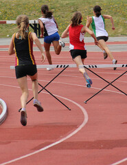 Girl running track and field - 496341924