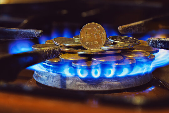 gas stove burner with russian ruble coins on top, burning gas