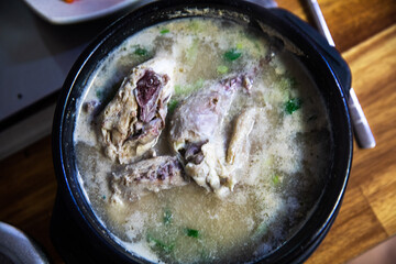 Nutritious samgyetang cooked with one chicken, glutinous rice, green onion, garlic, herbal medicine, and ginseng,