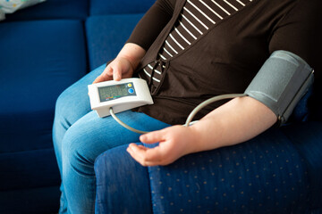 Women's health check blood pressure.and heart rate with digital manometer standard blood pressure...