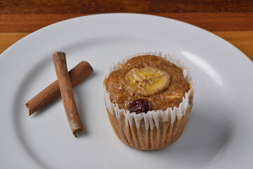 Banana muffin with cinnamon on white plate. Brazilian cuisine.