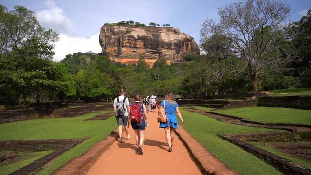 View of people walking in park below from Sigiriya rock. Ruins of Sigiriya Lion's rock palace.
