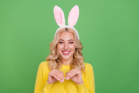 Photo of cute millennial blond lady wear ears yellow pullover isolated on green color background