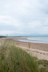 Llanddwyn beach on Anglesey Island in north Wales, with Snowdonia mountains seen across the water