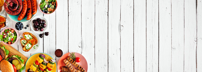 Summer BBQ or picnic food corner border. Variety of burgers, grilled meat, vegetables, fruits, salad and potatoes. Top view on a white wood banner background. Copy space.