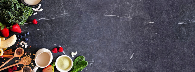 Healthy food corner border. Smoothie making concept. Top view on a dark slate banner background. Copy space. Fruit, yogurt, almond milk and a mixture of ingredients.