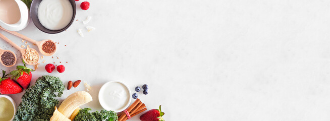 Healthy food corner border. Smoothie making concept. Top view on a white marble banner background....