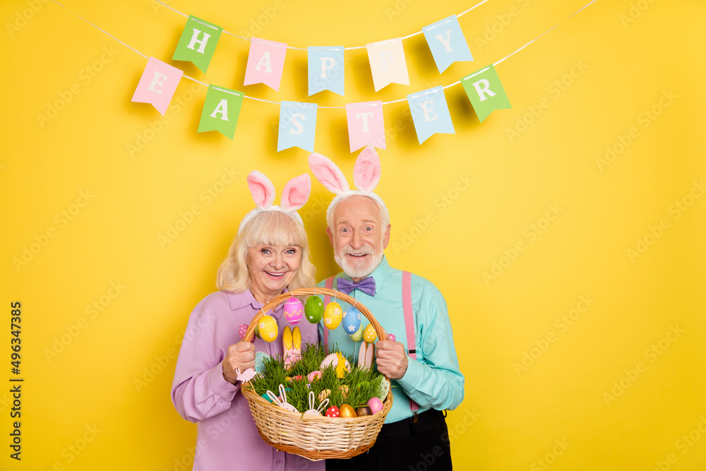 Canvas Prints portrait of two attractive trendy cheery grey-haired spouses happy easter food isolated over bright 