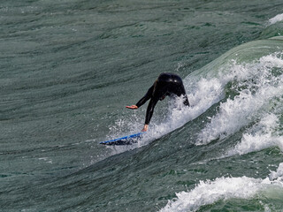 a surfer surf a wave in italy