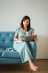 Vertical image of a psychologist taking notes on a video call from home. Copy space.