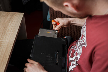 Man repairs laptop by himself, computer repair