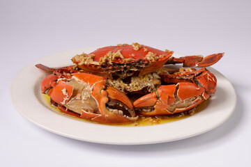BUTTER GINGER CRAB WOKKIN in a dish top view on grey background singapore food