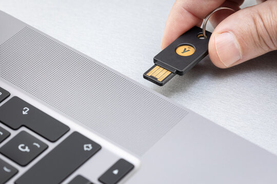 Galicia, Spain; April 1, 2022: Hand holding a Yubikey hardware key. Yubikey is a hardware authentication device manufactured by Yubico