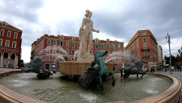 Nice, France, October 6, 2021:  Fontaine du Soleil, the Sun Fountain in Place Massena. This fountain features a statue of Apollo, who symbolizes the sun, along with bronze statues that denote planets.